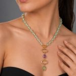Model wearing Raga Necklace featuring mint green beaded strand with gold-plated multi-stone drop pendant in a minimal elegant style